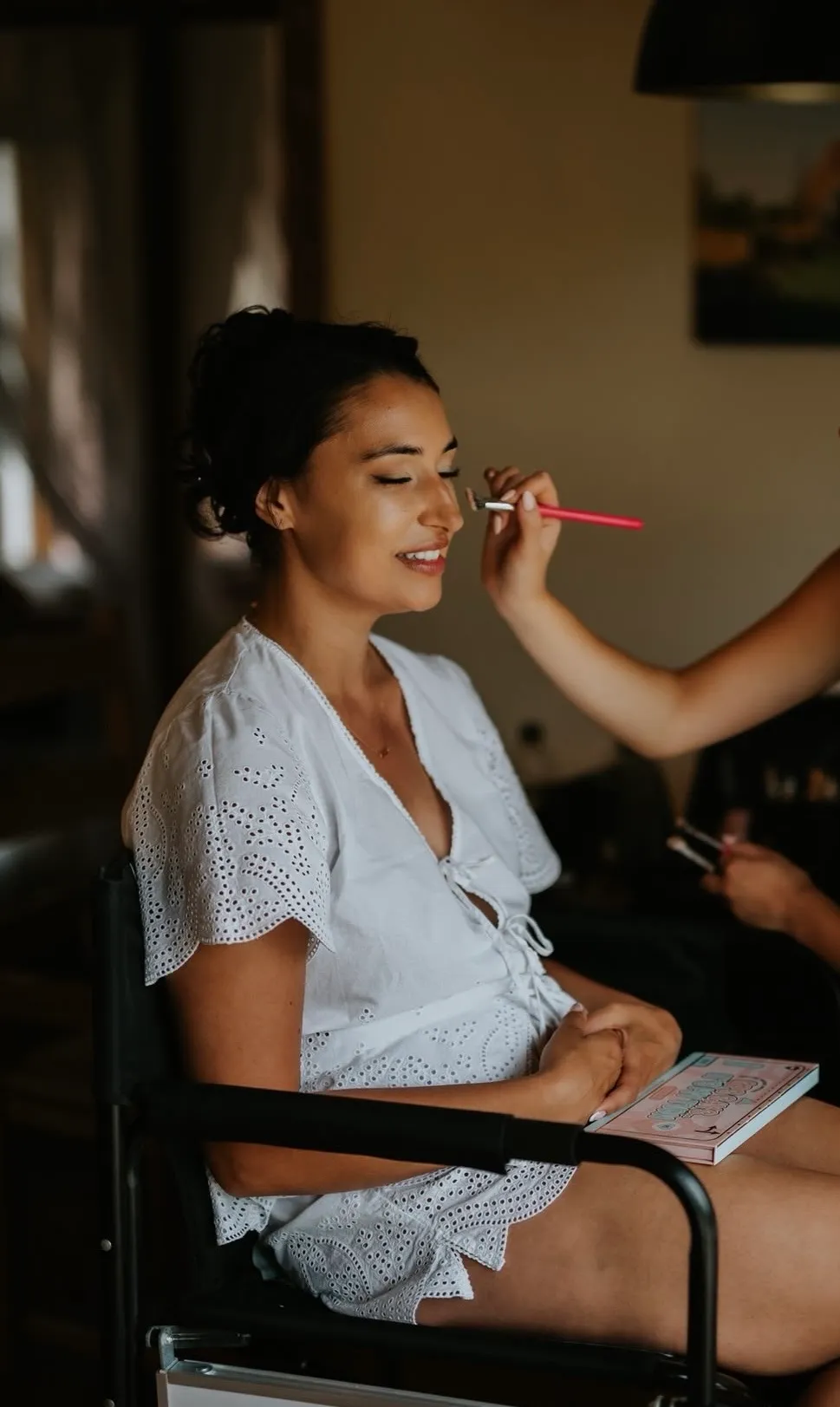 Lucy applying eyeshadow to a bride on her wedding morning